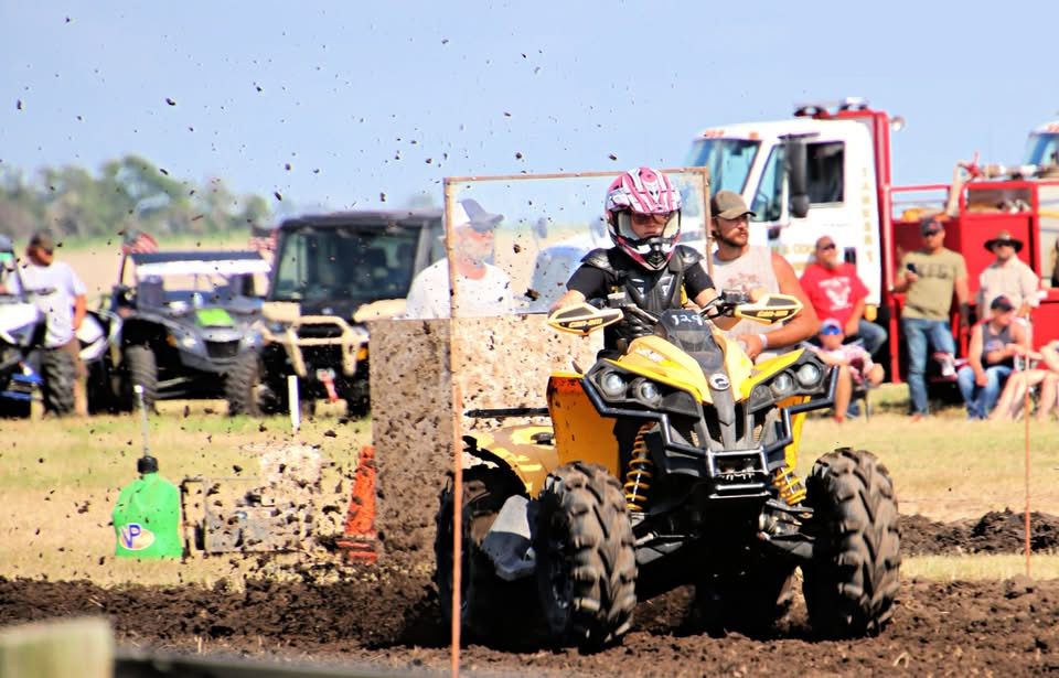 MaKayla racing an ATV through the mud